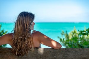 Portrait shot of a woman on a park bench.