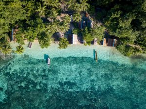 Aerial view of small huts at tropical water.