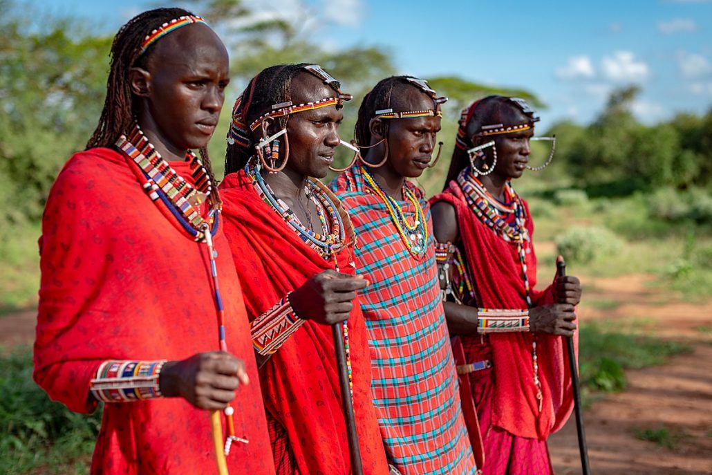 Portrait of four Massai warriors in their traditional robes.