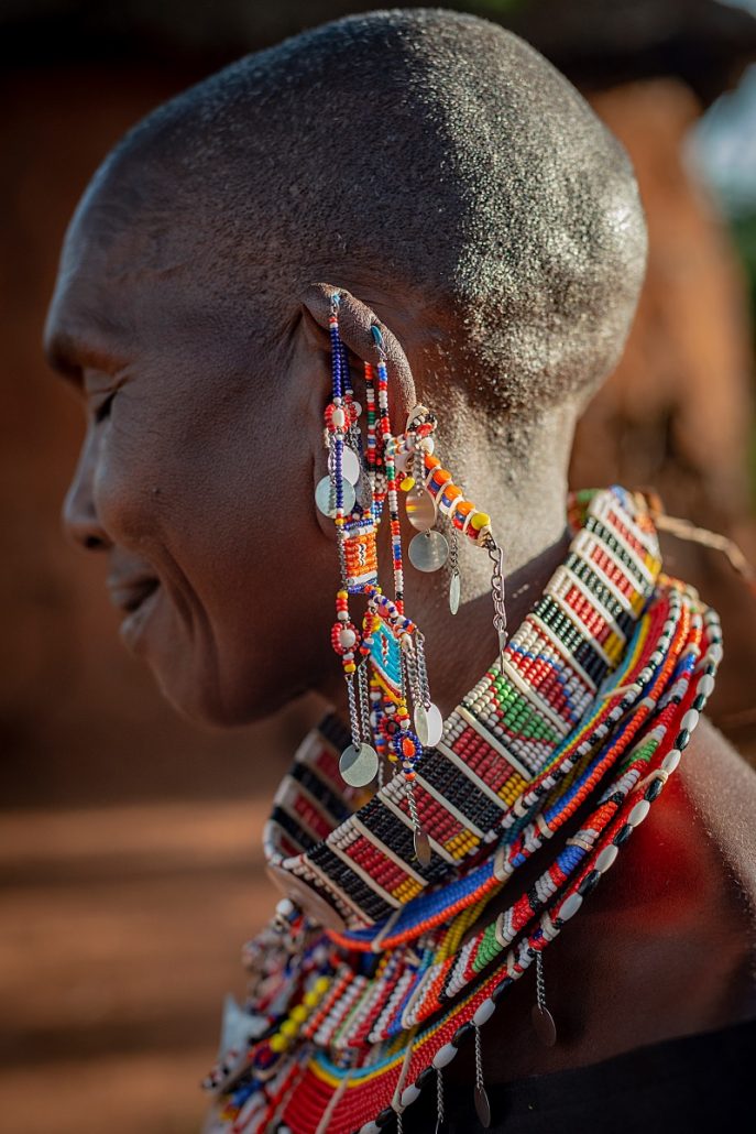 Portrait and close-up of the traditional ear- and necklace of a Masai woman.