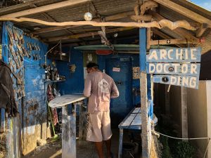 Portrait of a surfboard workshop in Bali with blue walls.