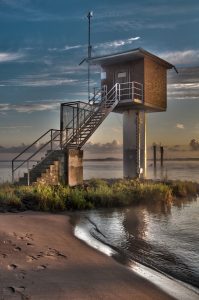 Landscape shot of a little house at the river.