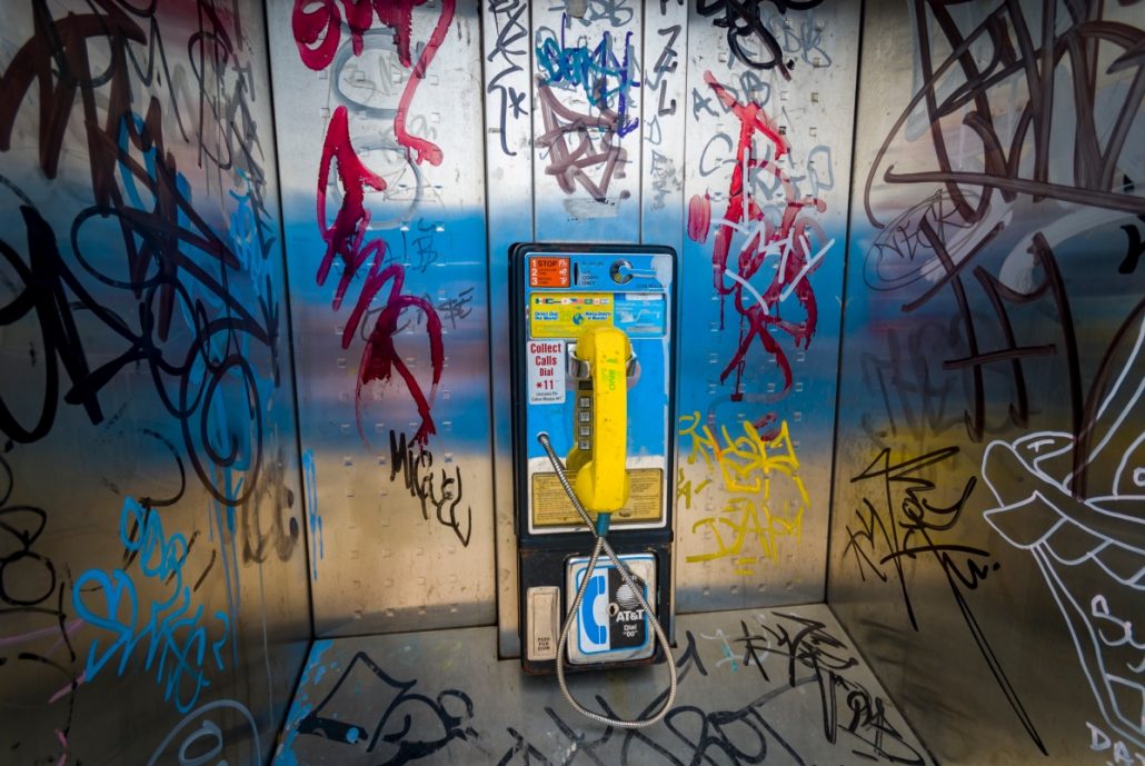 Urban close-up of a colorful phone booth.