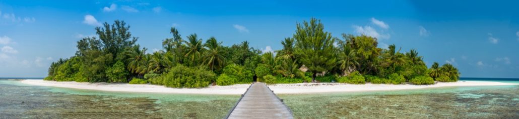 Panoramic view from a palm island with pier.