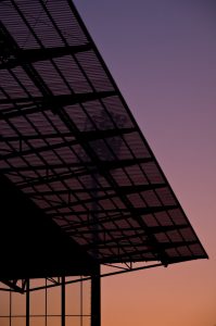 Urban shot of a stadium roof at sunset.