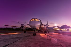 Night photography of an airplane on the runway at sunset.