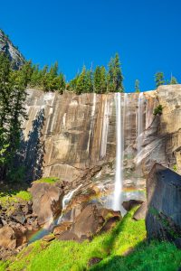 Landscape shot of a waterfall with rainbow.