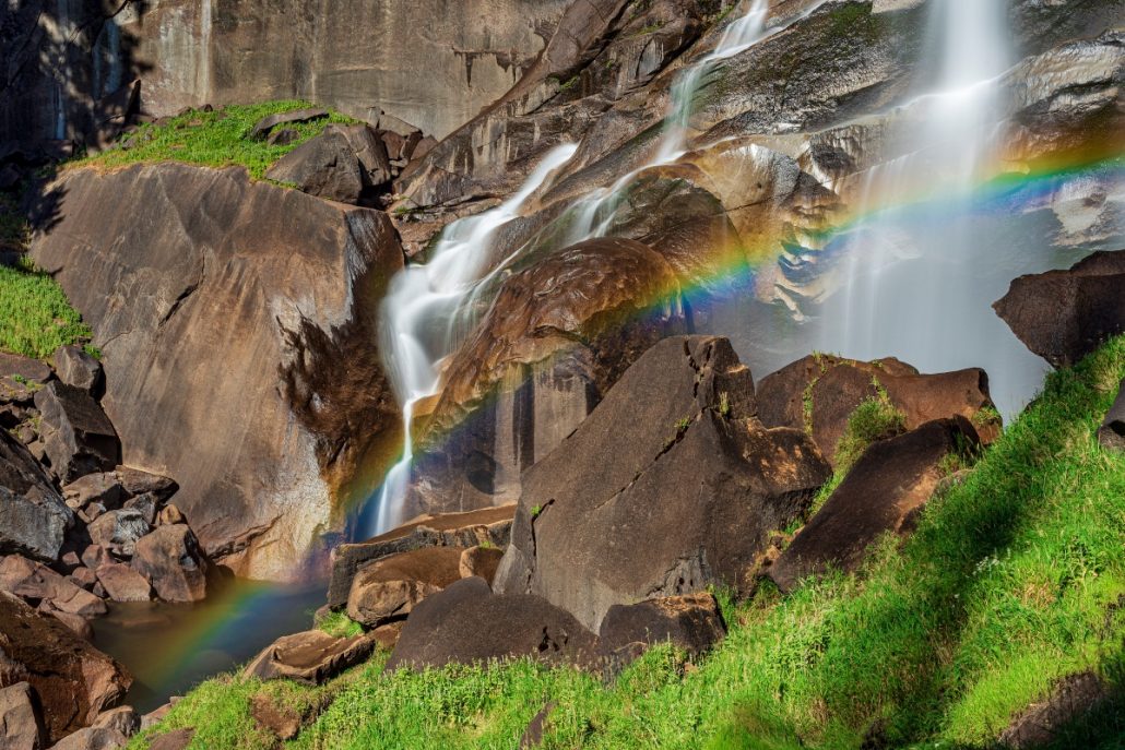 Landscape shot of a waterfall with rainbow.