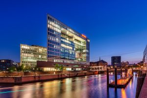 Night photography of your glass skyscraper on a canal.