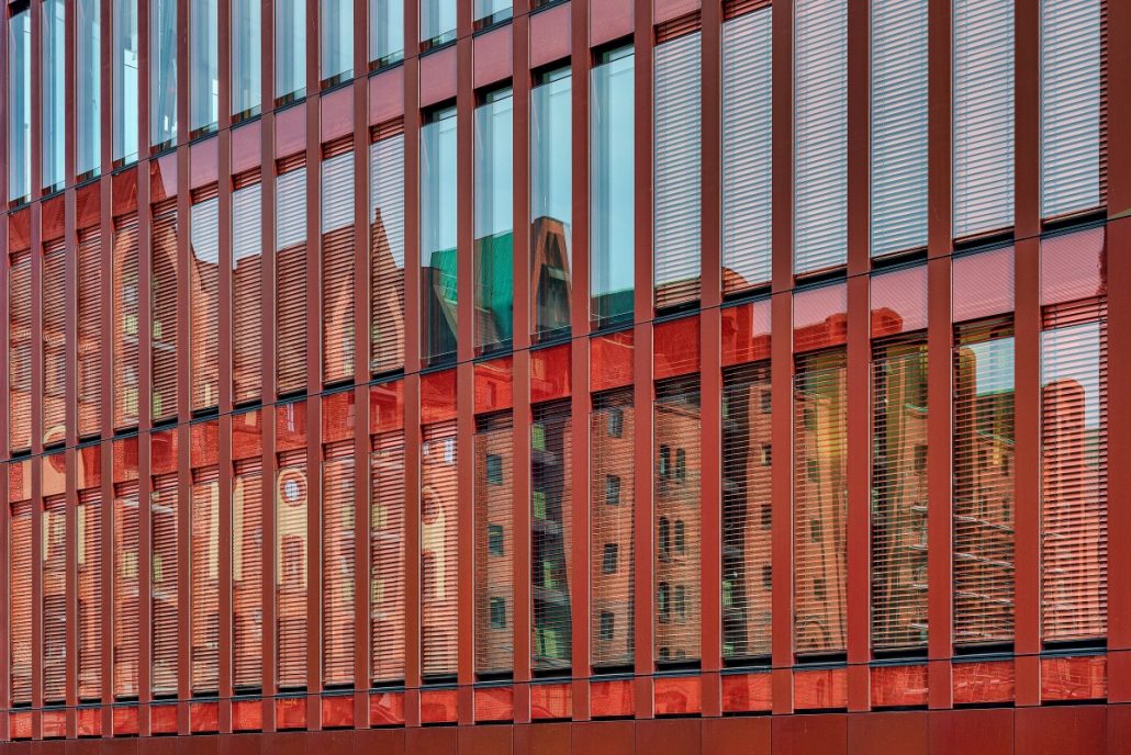 Architecture Image of a reflection of old brick houses in a modern glass building.