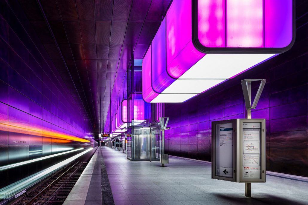 Night photography of a subway station with violet lights.