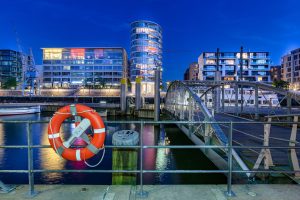Night shot of a bridge construction in front of modern houses in Hamburg's Speicherstadt.
