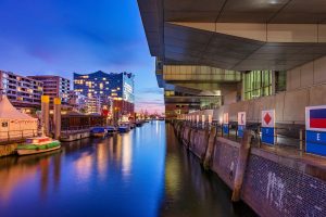 Night photography of a channel with houses at the blue hour.