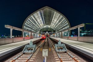 Night shot in the middle of the tracks of a railway station.