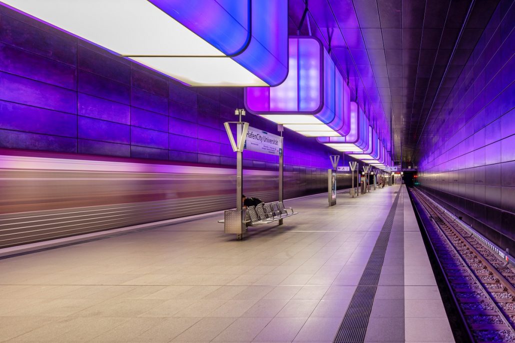 Night photography of a subway station with violet lights.