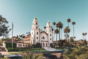 Architecture shot of the white Beverly Hills Presbyterian Church in front of palm trees.