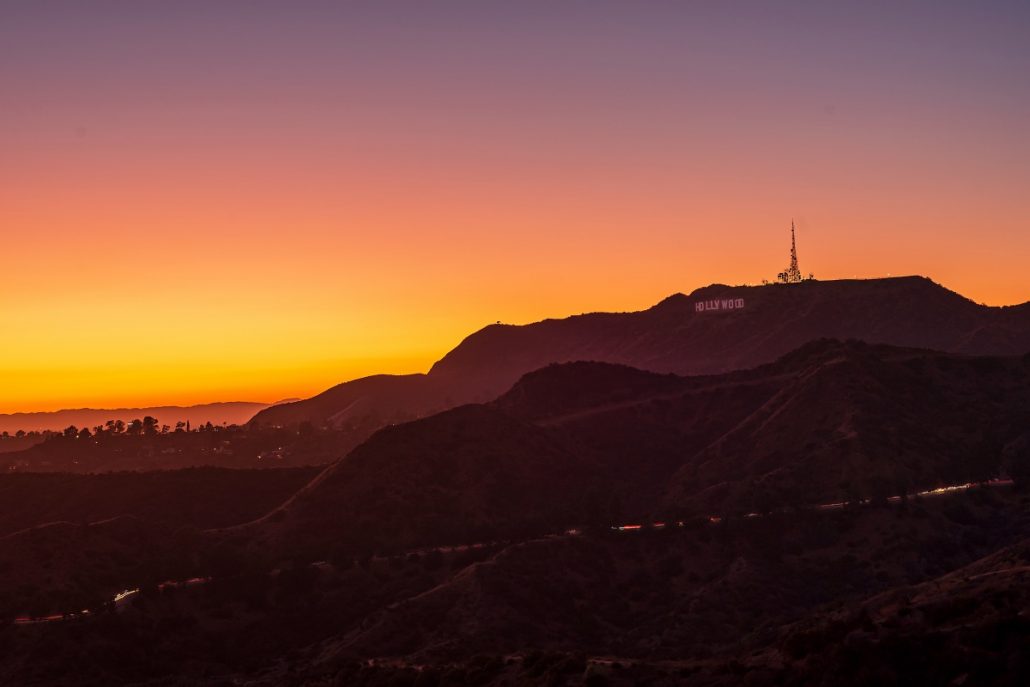 Night shot of the Hollywood sign in Los Angeles at sunset.