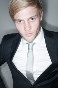 Portrait photo of a man in a suit.