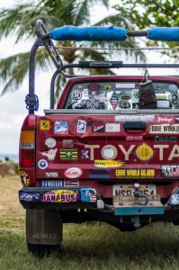 Urban close-up of a vehicle with stickers.