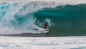 Portrait Picture of a surfer in the wave.