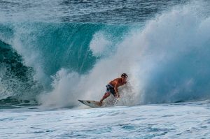 Portrait Picture of a surfer in the wave.